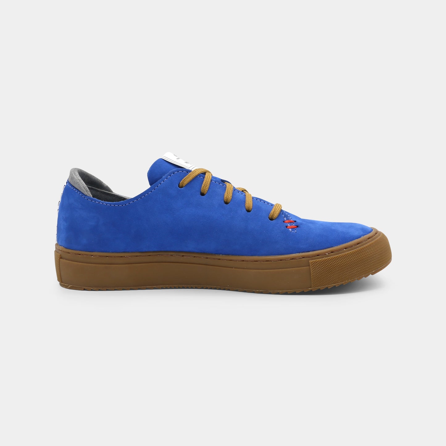 A blue low-top sneaker with a brown sole and laces, medial view.