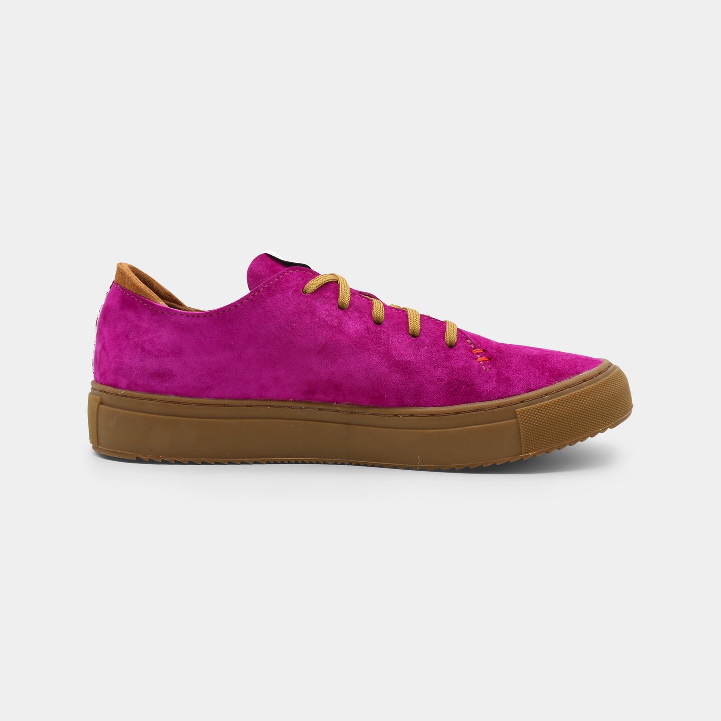 A pink low-top sneaker with a brown sole and laces, medial view.