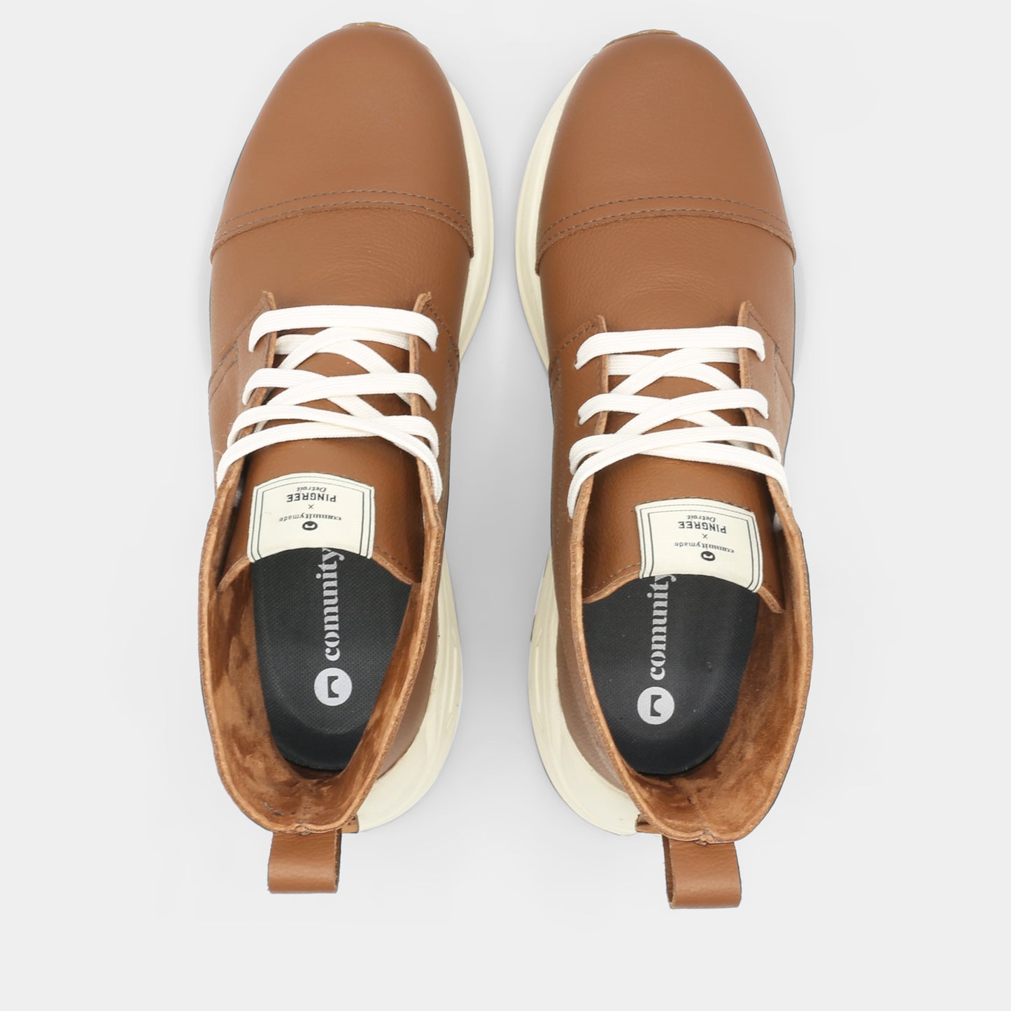 A brown high-top urban utility chukka boot with white laces and a chunky white sole top view.