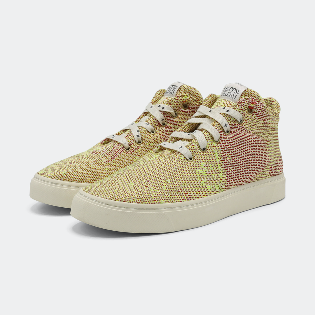 Mid-top sneakers with a camouflage pattern in yellow and pink colors, featuring lace-up closure quarter view