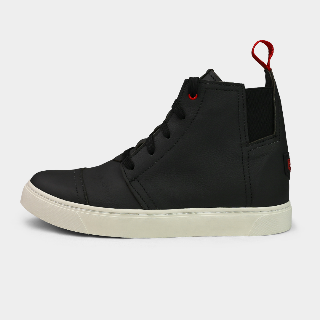 A pair of black, high-top sneakers with lace-up closure, featuring a solid pattern and a red pull tab on the heel.
