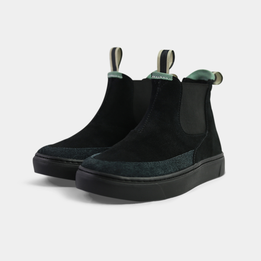 A pair of black suede boots. The shoes have black elastic gussets on the side and a striped pull tab at the heel. The black insoles feature a white