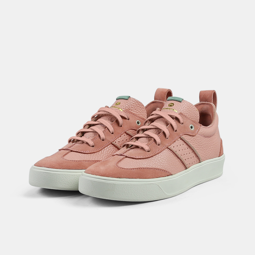 A pink men's sneaker with a lace-up closure, made from Italian leather, with a rubber cupsole quarter view