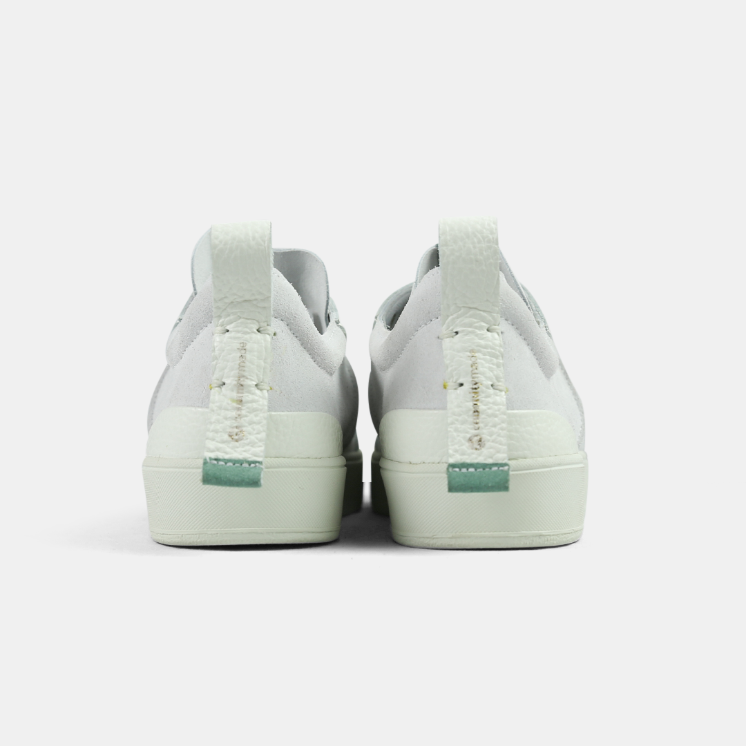 A white men's sneaker with a lace-up closure, made from Italian leather, with a rubber cupsole back view