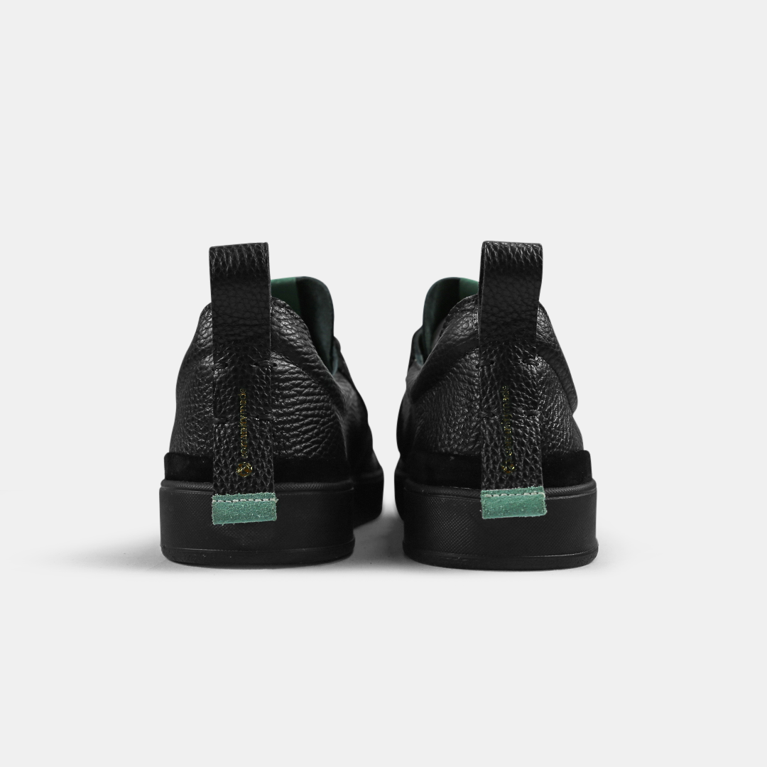 A black men's sneaker with a lace-up closure, made from Italian leather, with a rubber cupsole back view