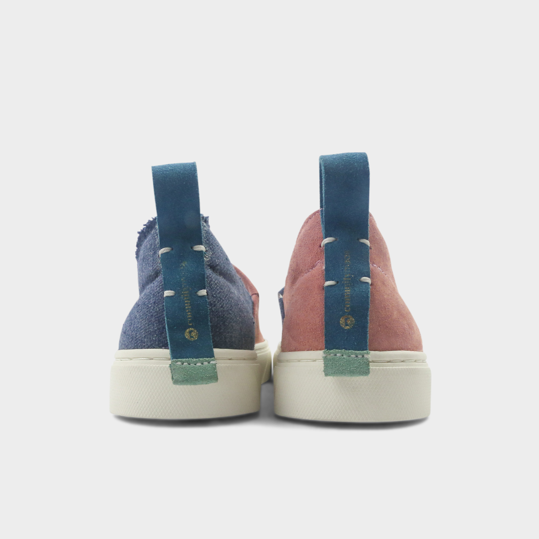 A pink and blue slip-on men's shoe with a suede and manmade material upper and a rubber sole back view