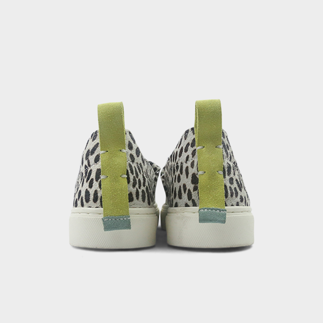 A cheetah print slip-on men's shoe with a suede and manmade material upper and a rubber sole back view