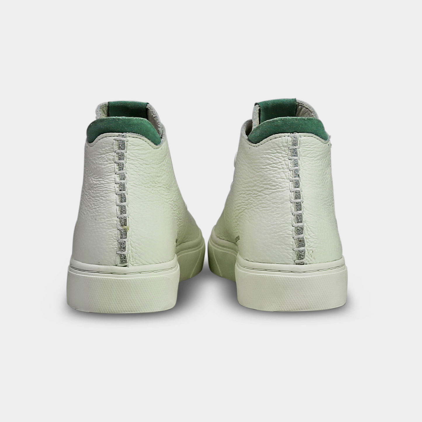 A white, mid-top sneaker with a leather upper, lace-up closure, and a white sole back view
