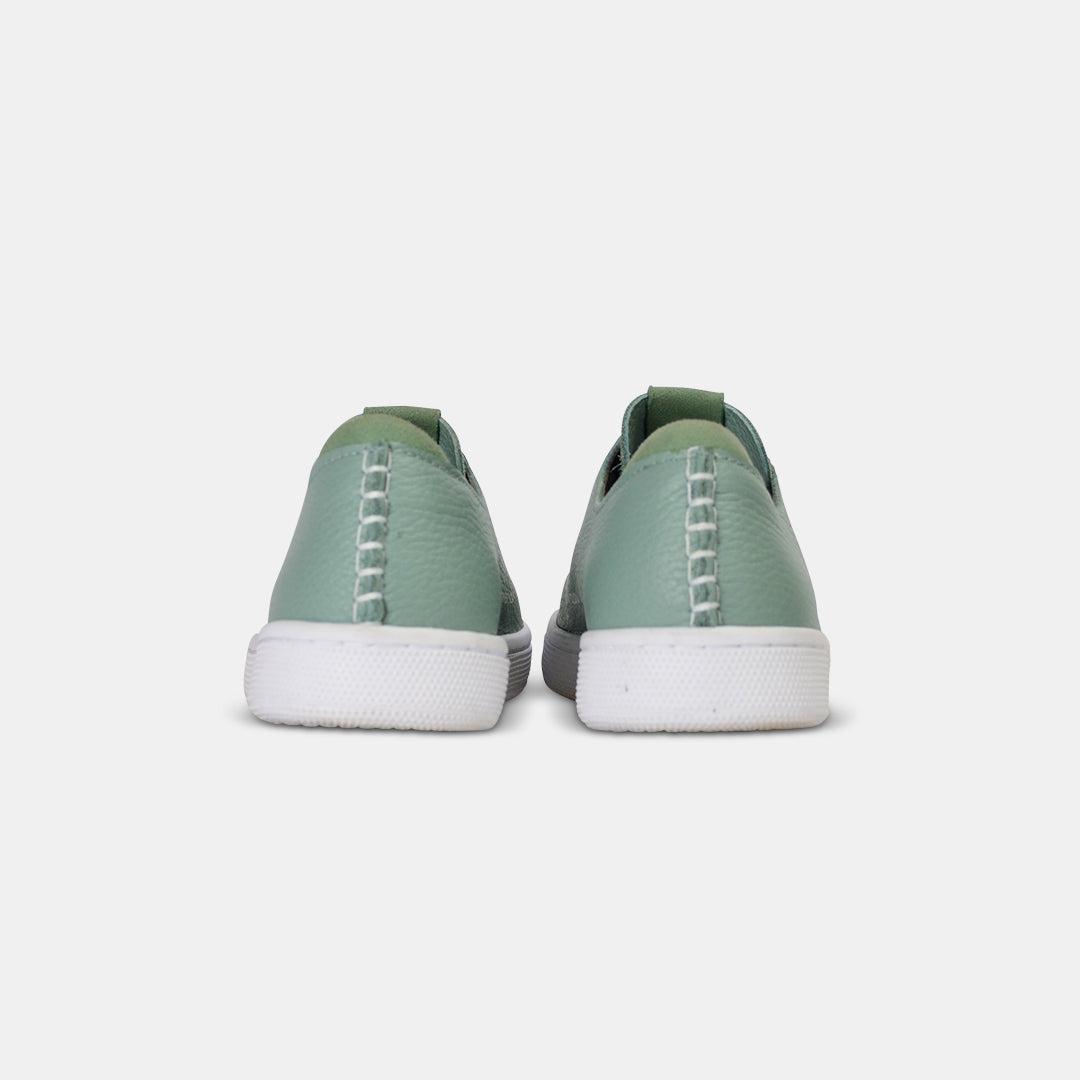 A rearview shot of a pair of light green leather sneakers with white accent stitching on the heel, a white rubber cupsole sole and a green accent on the heel and tongue.