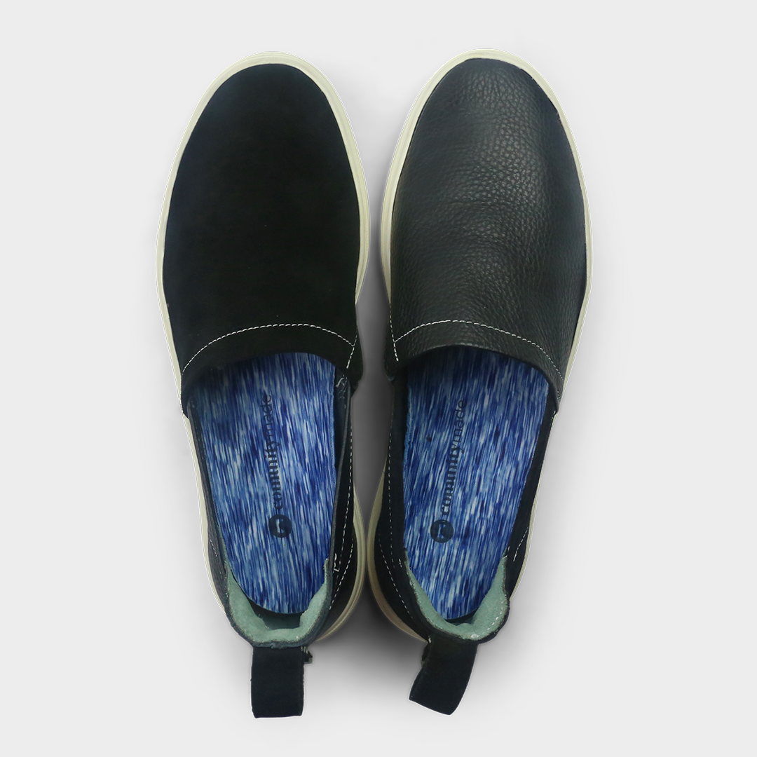 A black slip-on men's shoe with a suede and leather upper and a rubber sole top view