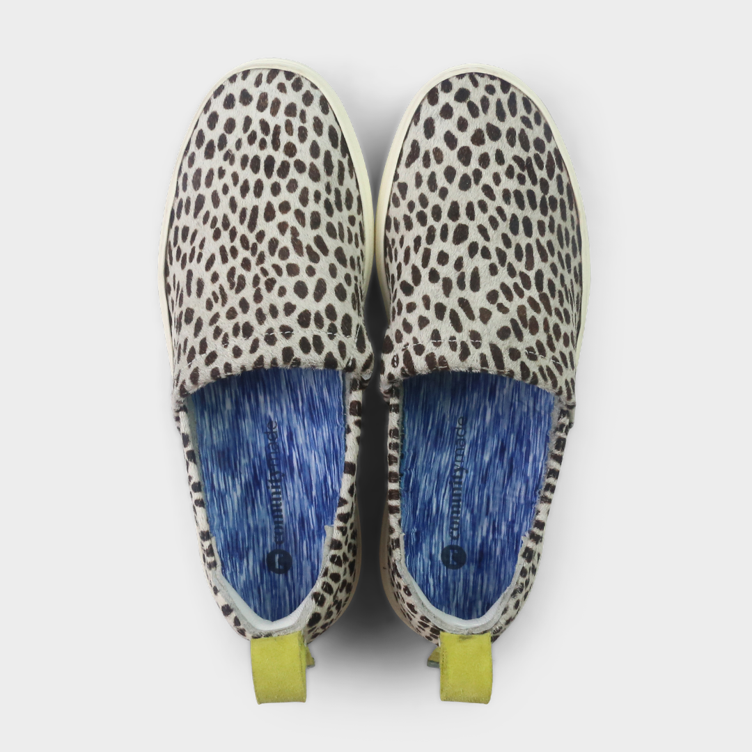 A cheetah print slip-on men's shoe with a suede and manmade material upper and a rubber sole top view