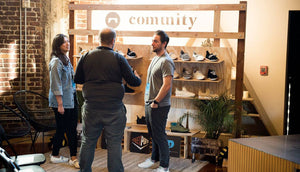 comunitymade interior shot with an artisan talking to two people