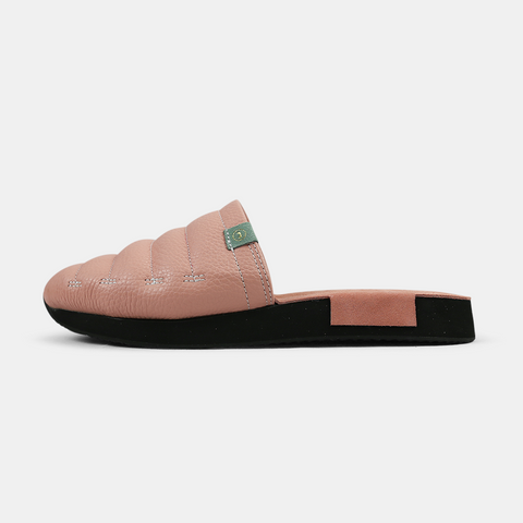 A women's Mateo slipper in pink with a black rubber outsole, featuring a quilted design and a metallic accent on the top lateral view