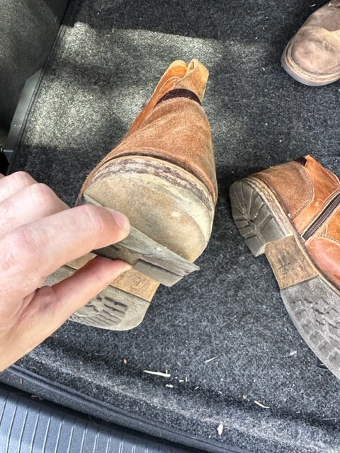 
                      
                        Broken Steve Madden shoes, with the sole worn off the heel.
                      
                    