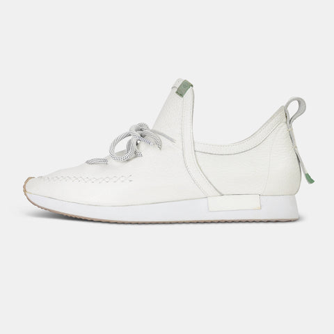 A single profile shot of a casual white leather mid-cut slip-on shoe with unique stitch detailing on the toe.  Round white laces with heel loop pull tab and a white midsole and rubber outsole.